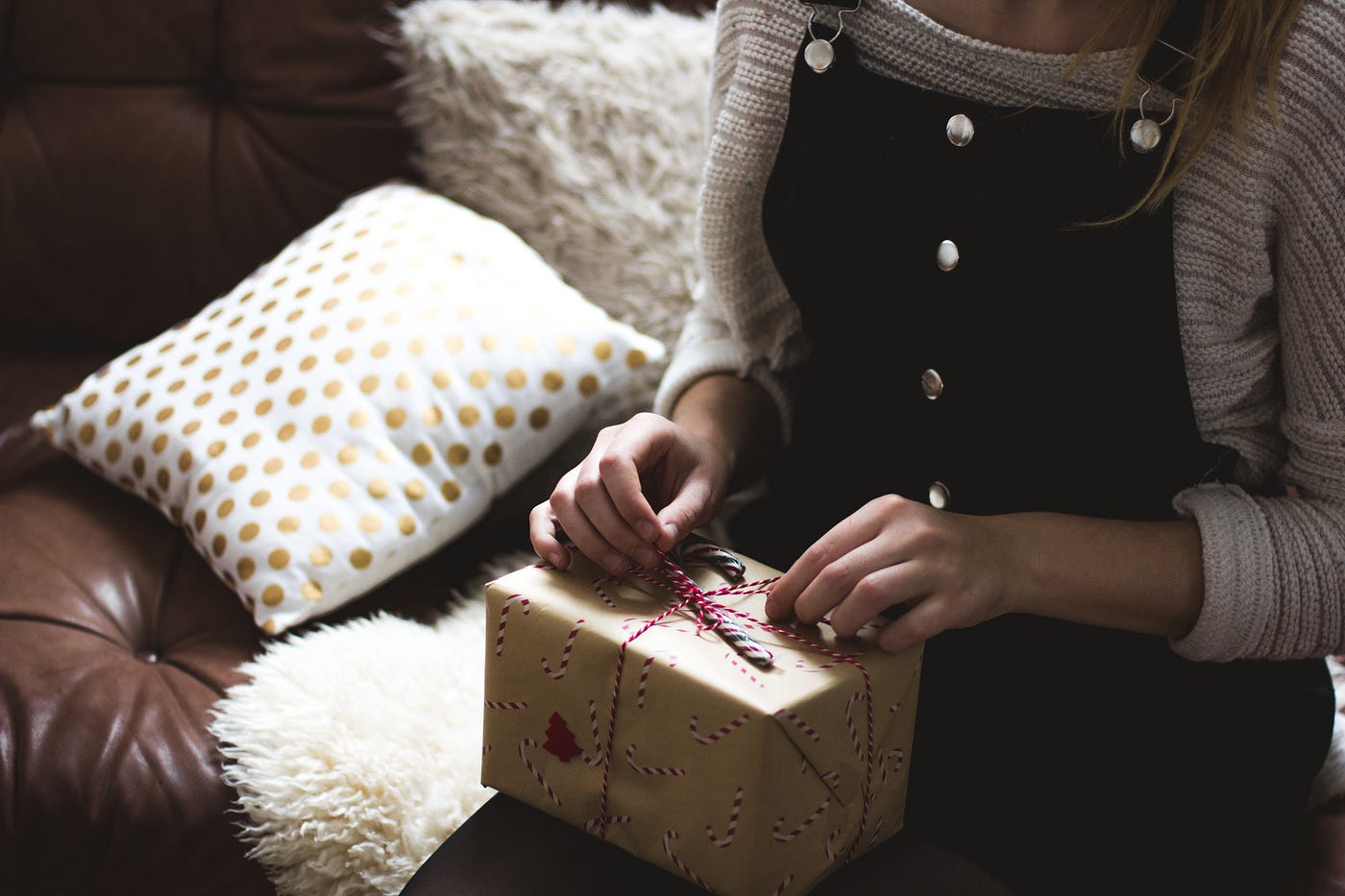 A picture of a woman opening a gift box