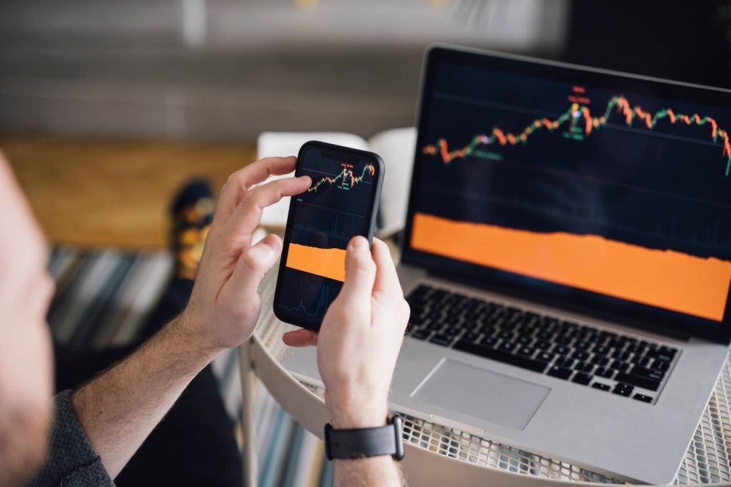 Work at home: Man Analyzing Crypto Graph On Laptop Screen.
