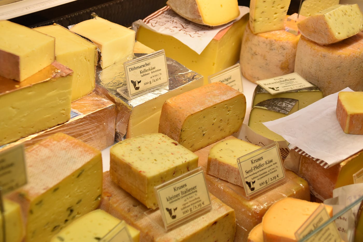display of blocks of cheese at a supermarket