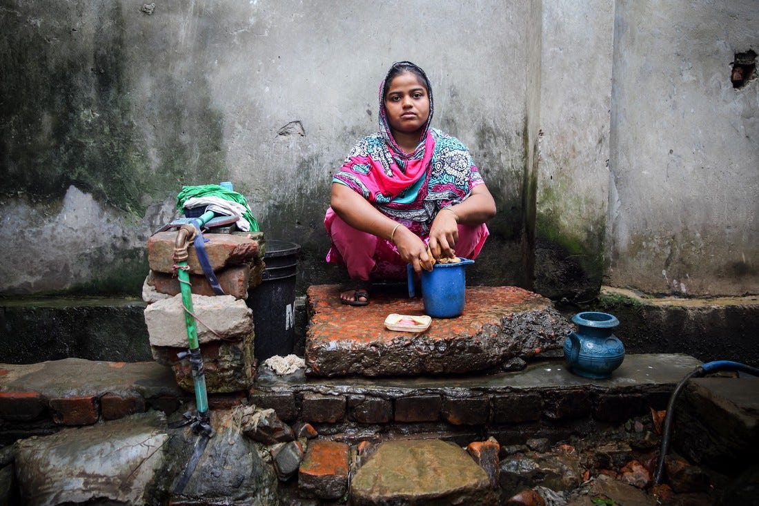 Rasheda washes clothes in Chittagong, Bangladesh. She shares a water tap with 25 other people. Credit: GMB Akash/Oxfam