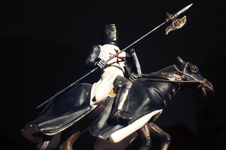 A crusader on a horse fully armed for battle.