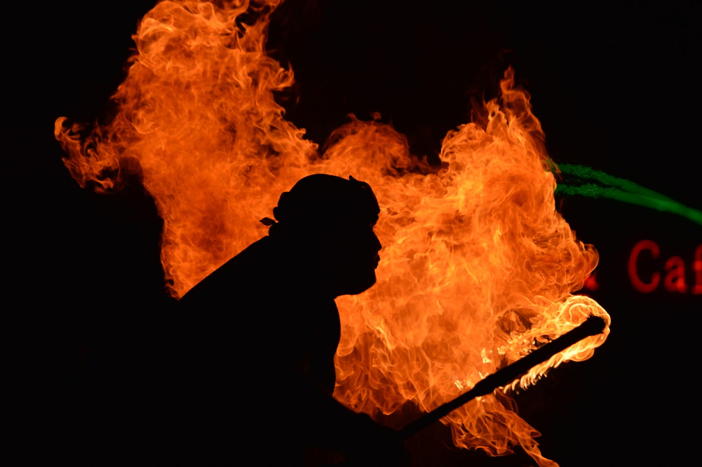Man standing amid fire holdings firey torch