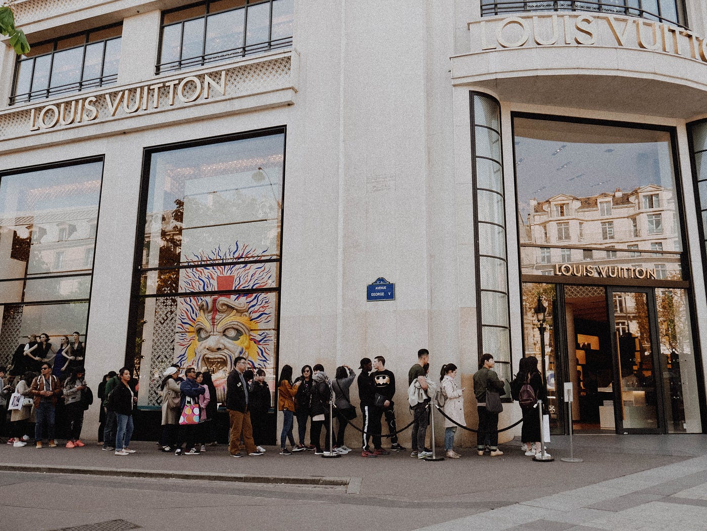 A line of people waiting at a store to represent what a queue looks like