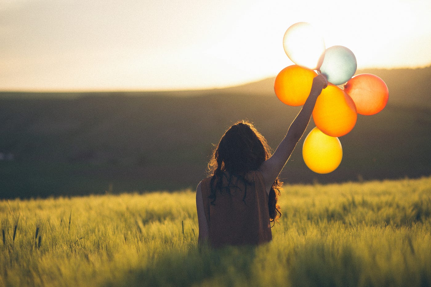 A girl holding a baloon