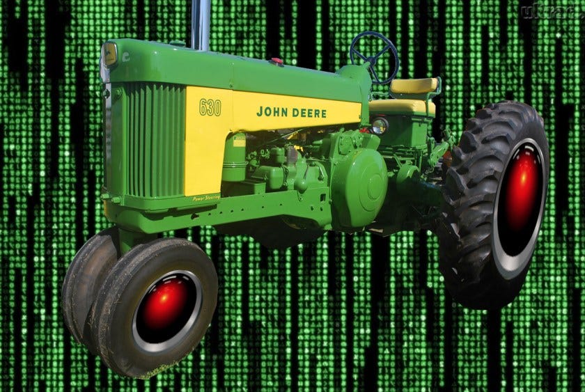 A vintage John Deere tractor whose wheel hubs have been replaced with HAL 9000 eyes, matted over a background of the cyber-waterfall image from The Matrix.