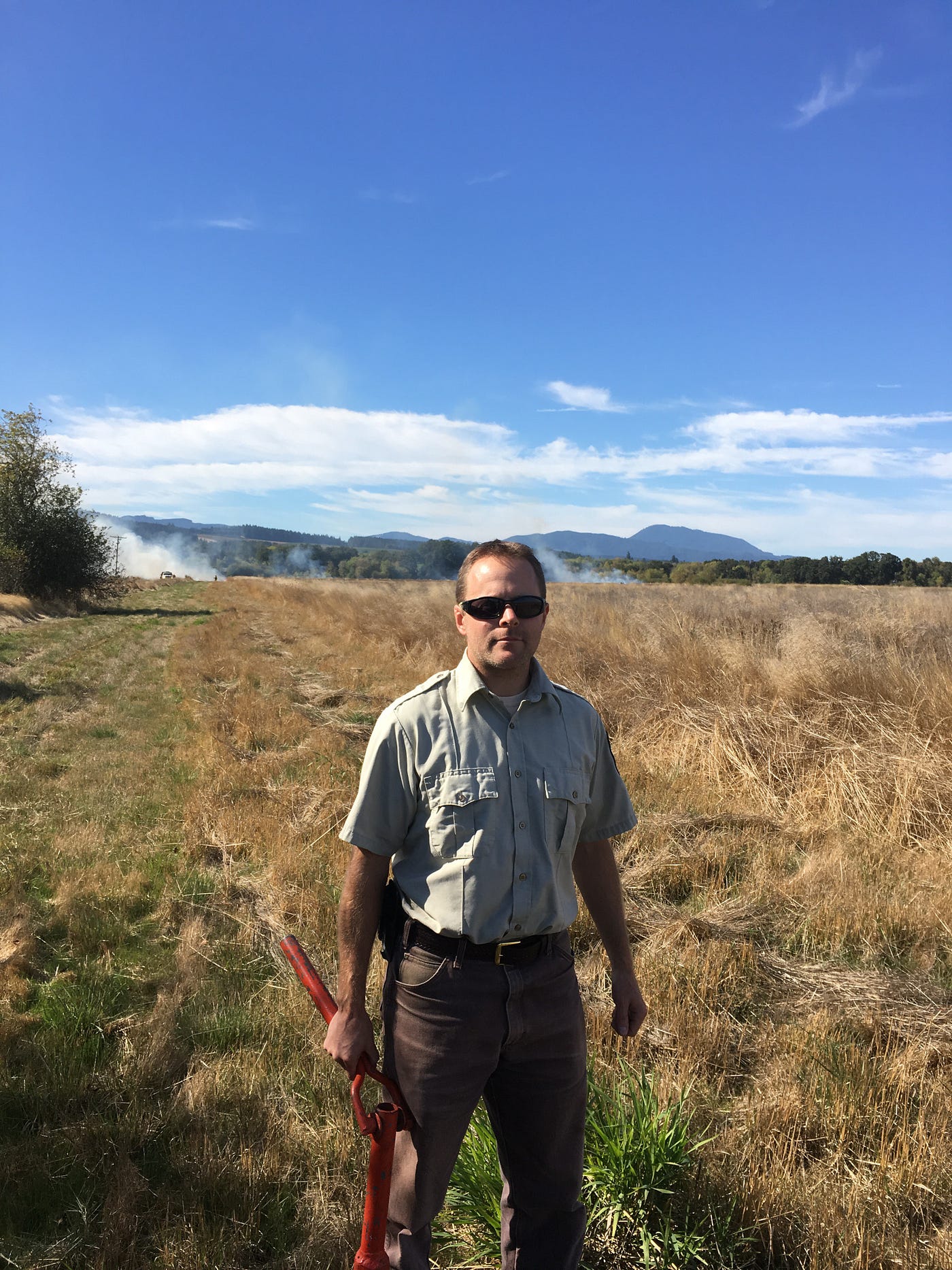 Jarod stands in dry fields in his USFWS uniform