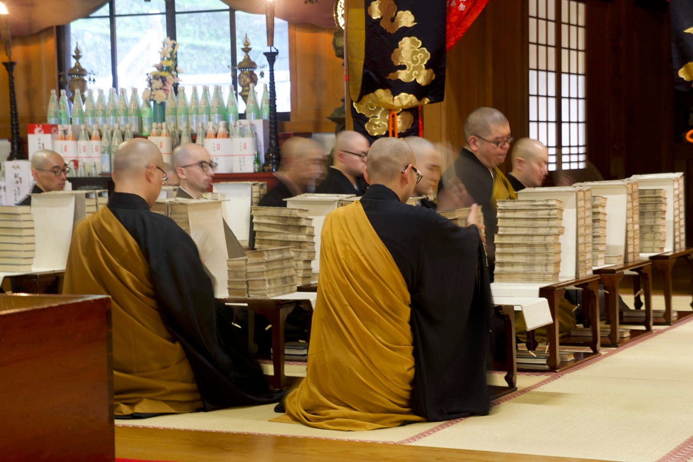 Monks at Zenpoji Temple, Tsuruoka City, in front of very thick books that contain the full version of The Heart Sutra.