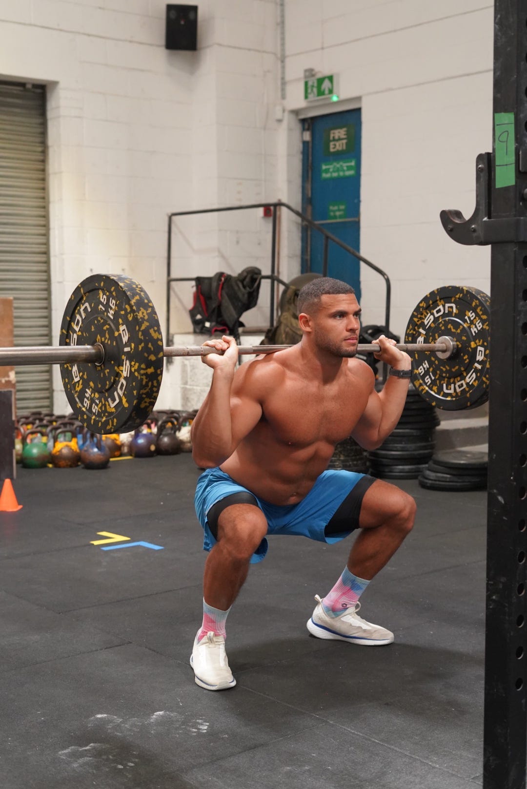 Zack George performing a squat.