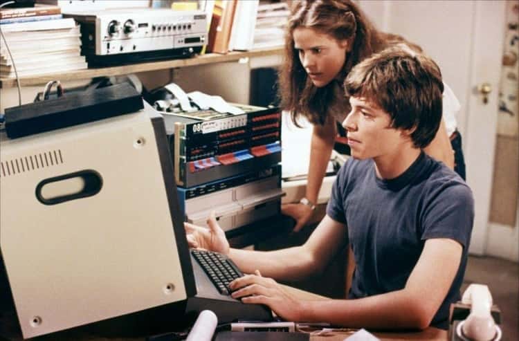 a photo if a man working on an old computer 