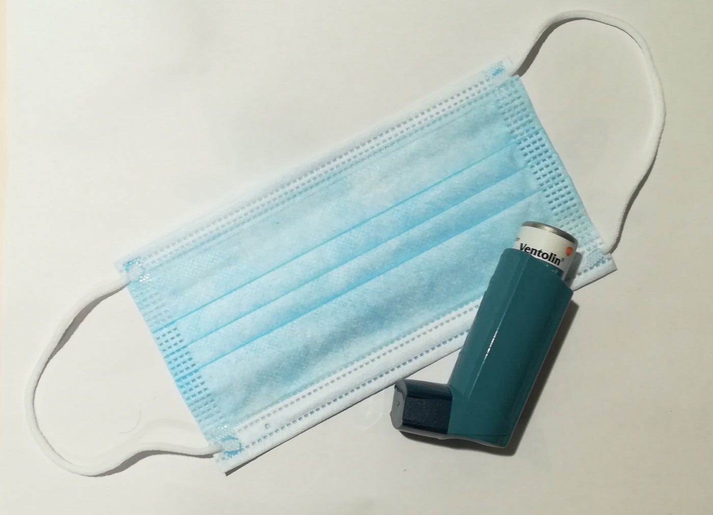 An asthma inhaler and a face mask