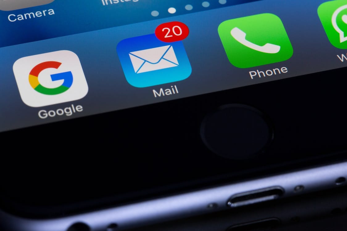 A close up of an iPhone screen showing 20 new emails in the inbox