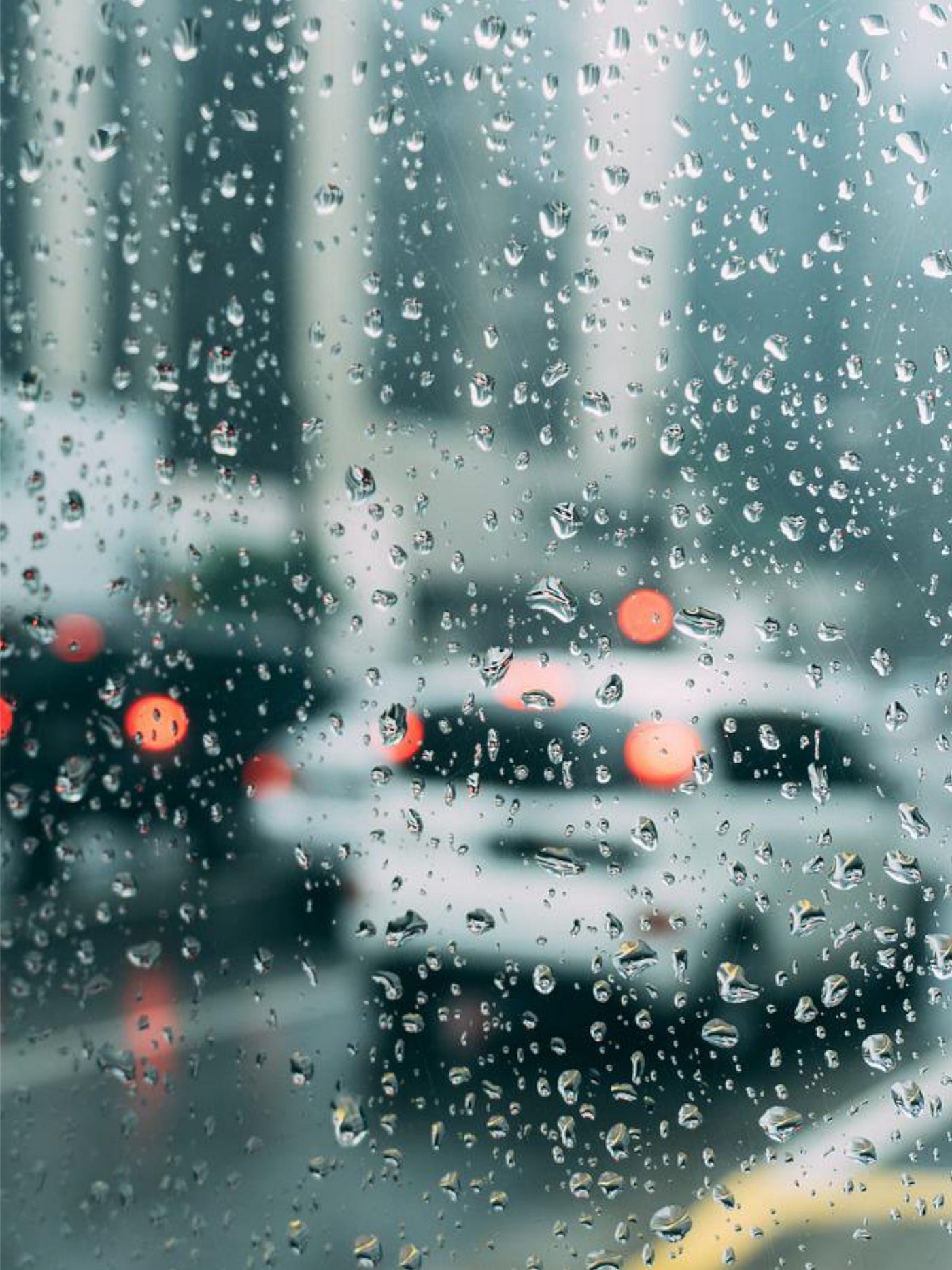 Daytime photo of rainy day traffic in the city.