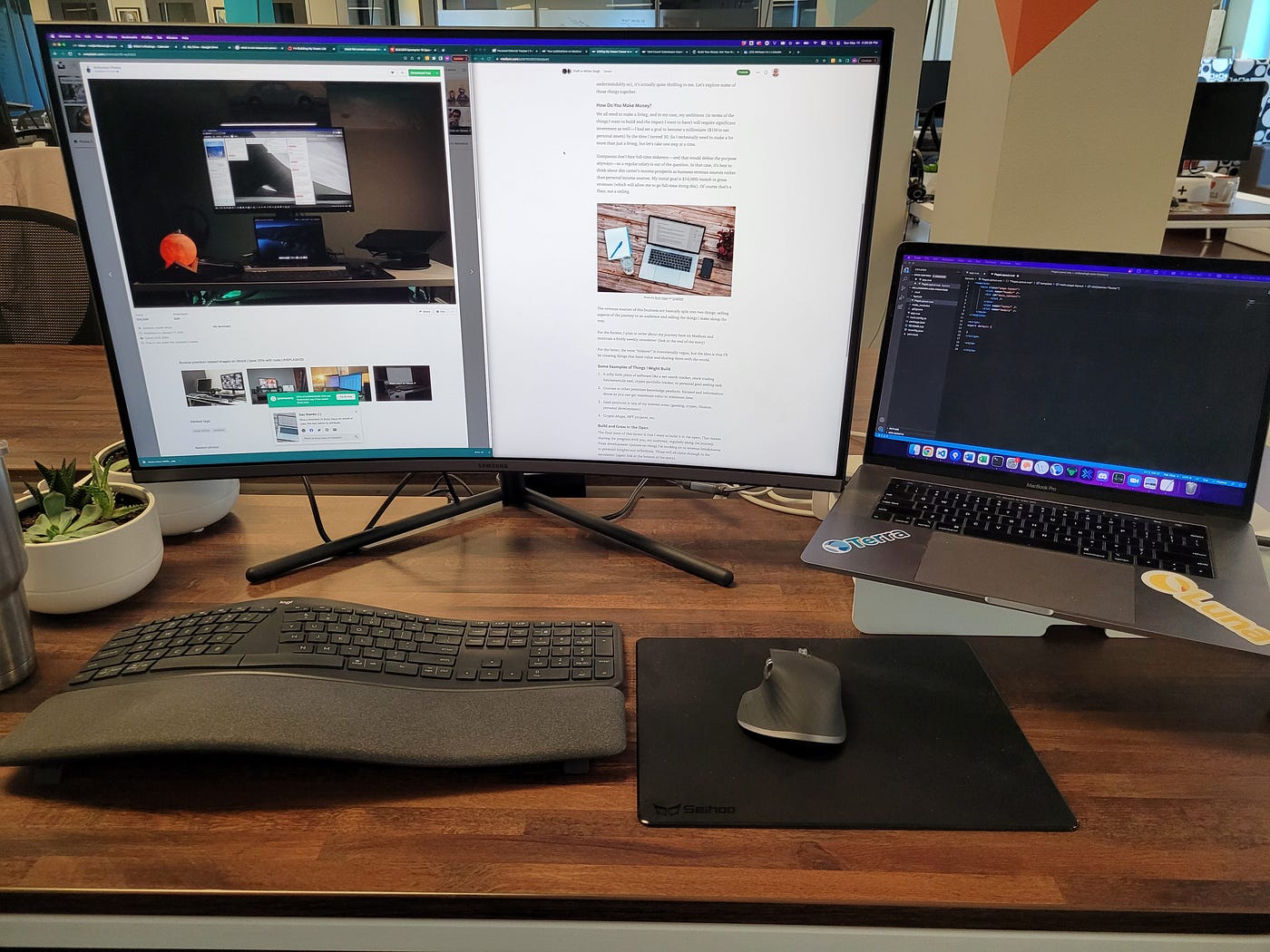 Large monitor next to a Macbook Pro laptop with a keyboard and mouse setup.