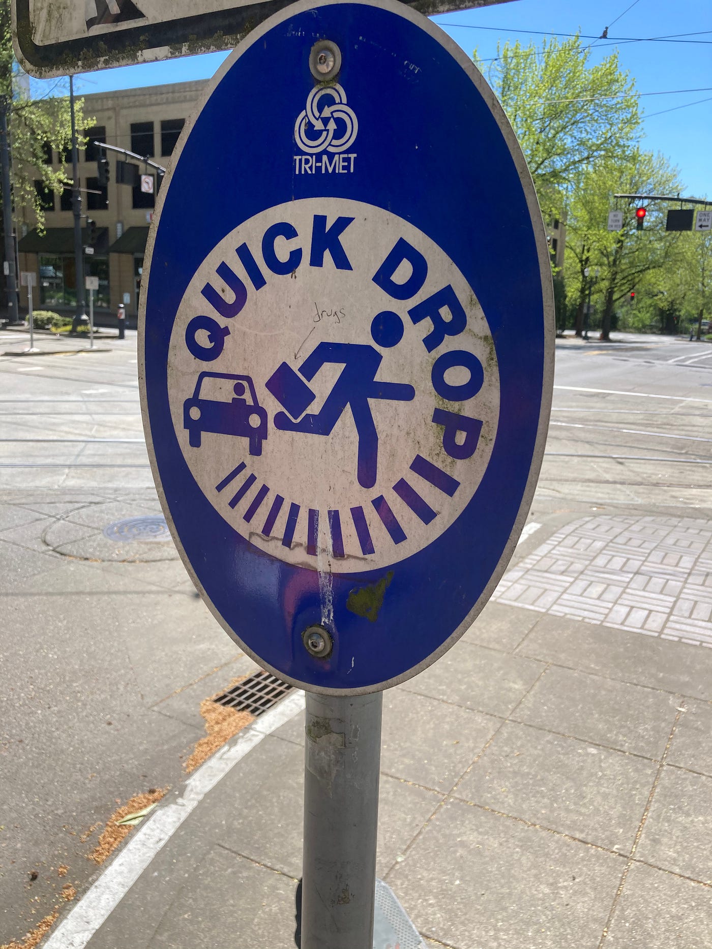 An old TriMet quick drop sign at Lloyd Center MAX station