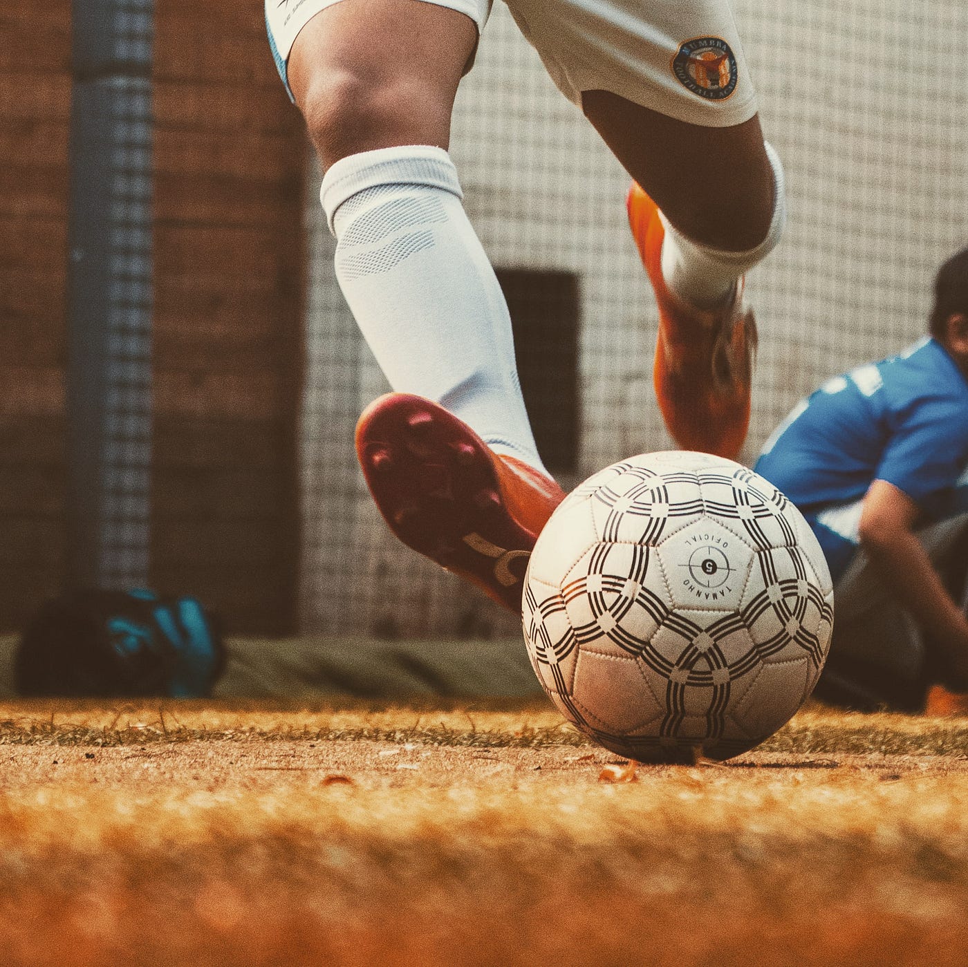 legs kicking a football