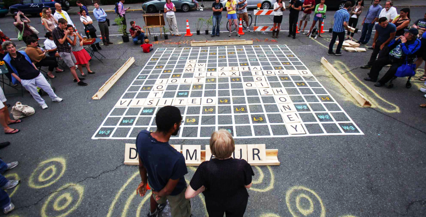 People around a human sized scrabble game