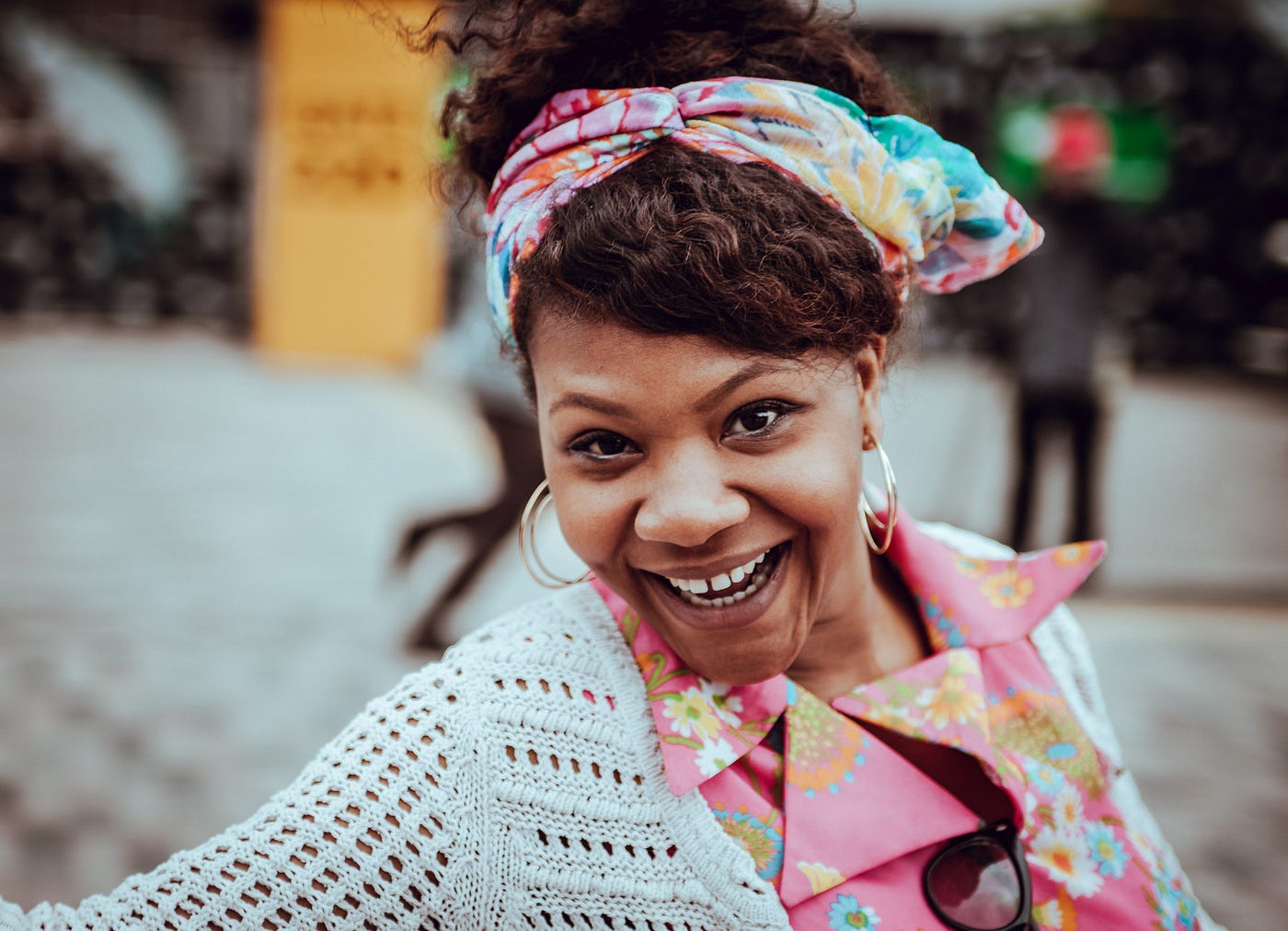 A lady in a colorful dress, all smiles