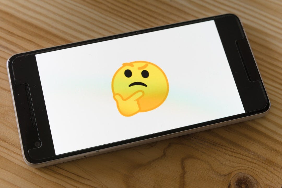 A thinking face on a smartphone.