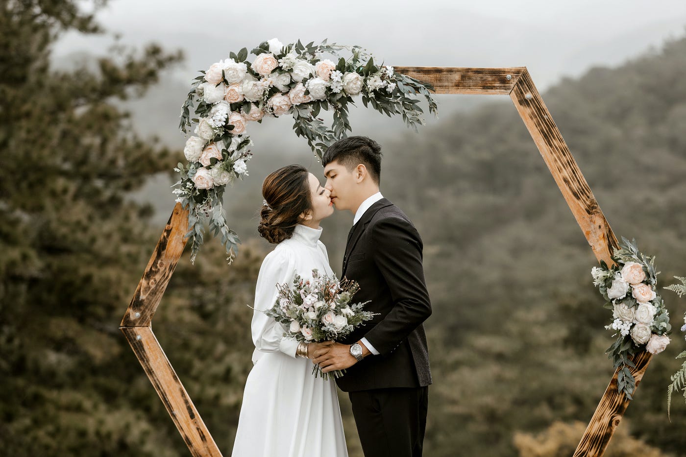 A wedding couple kissing at the altar