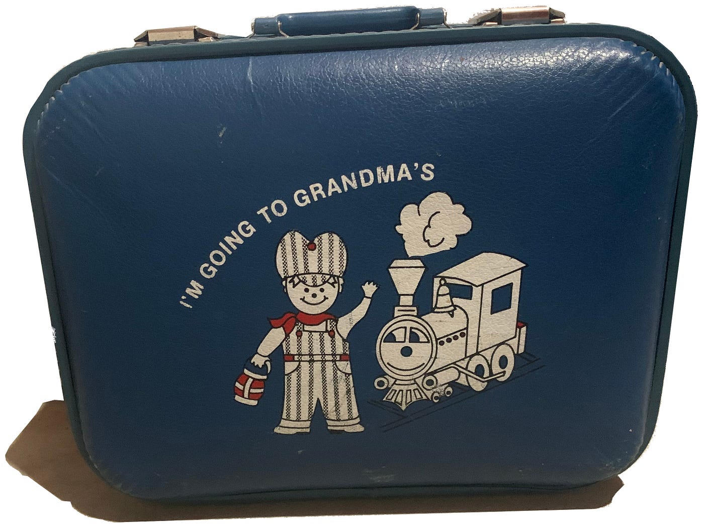 A small, blue suitcase with “I’m Going to Grandma’s” printed on the front.