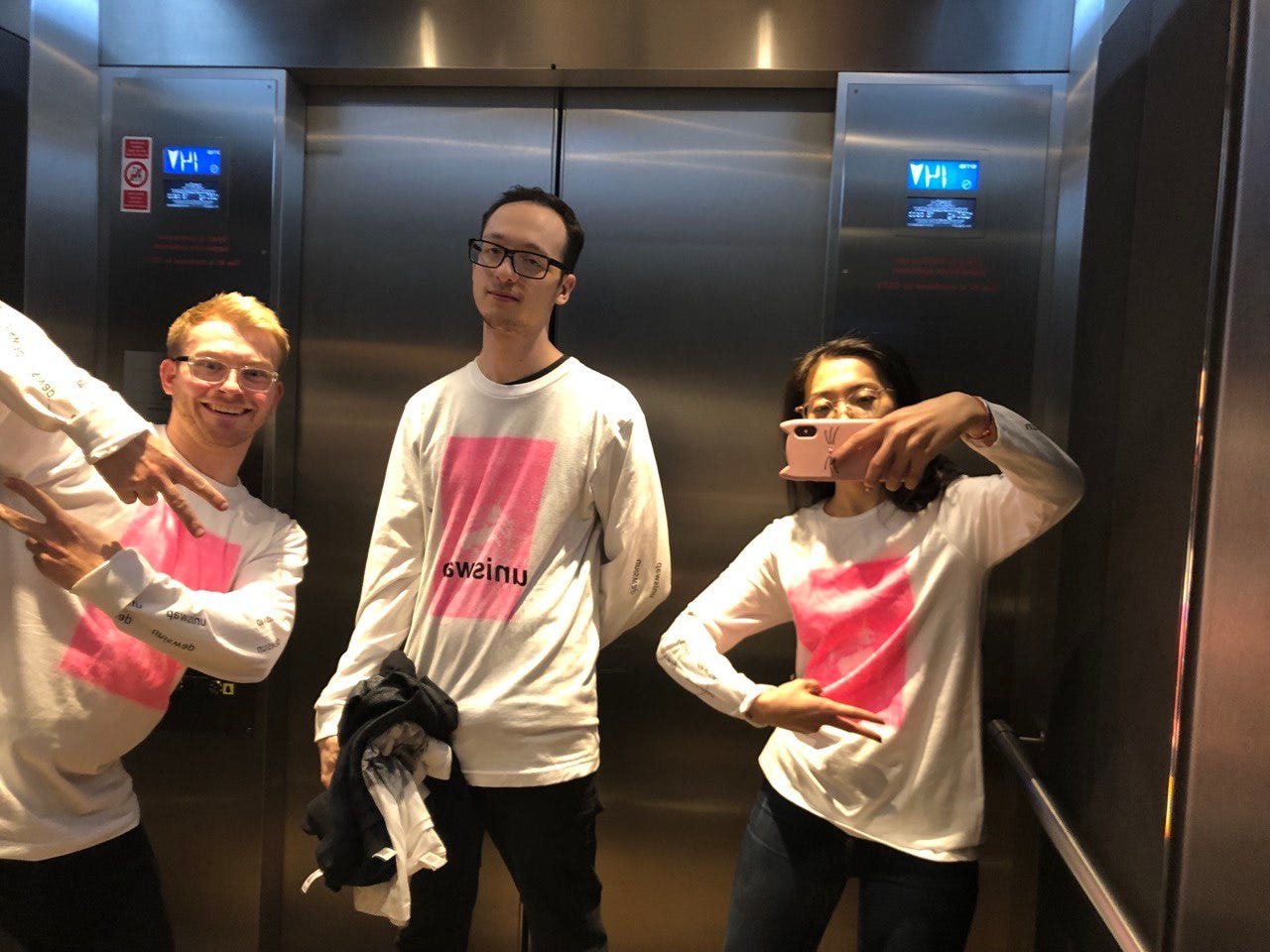 Uniswap and Optimism team members wearing the Uniswap launch tshirt