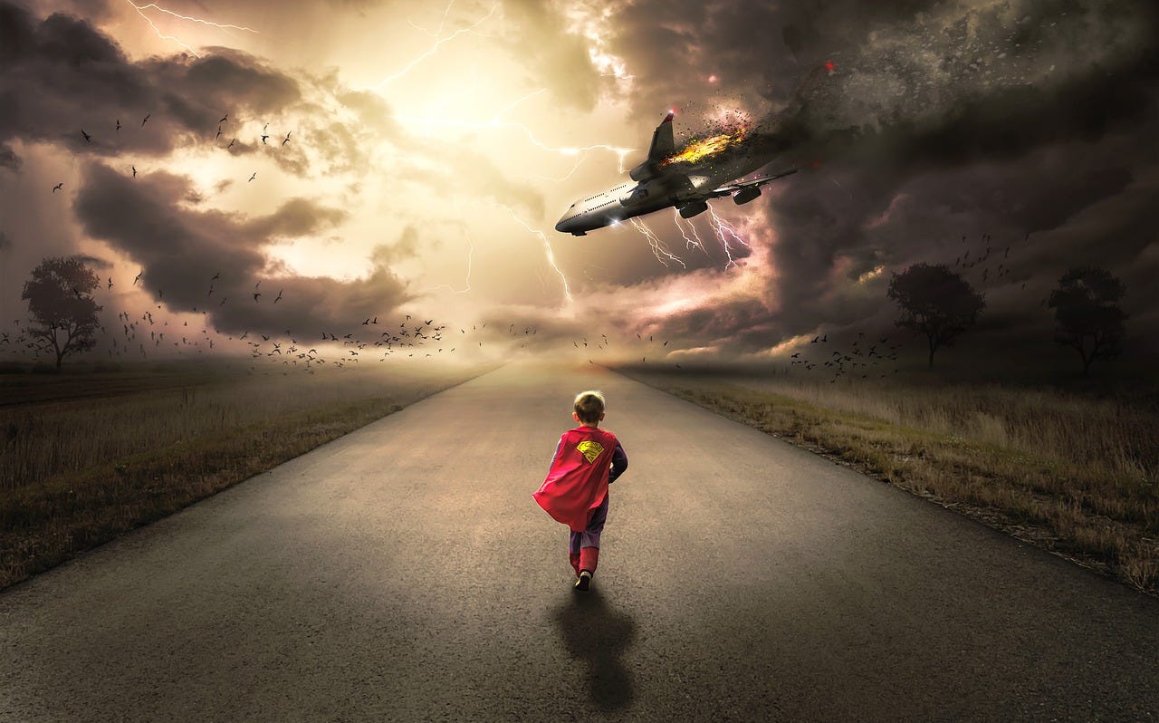 Boy dressed like superman running down an empty road toward a plane crash (plane being struck by lightning).