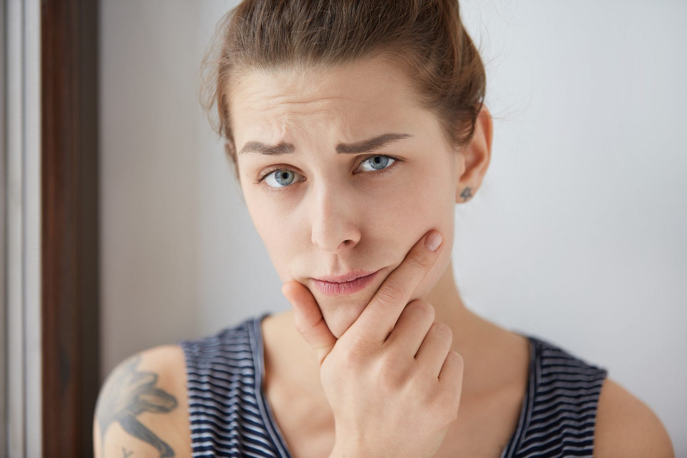 A woman stares at the camera judgmentally.