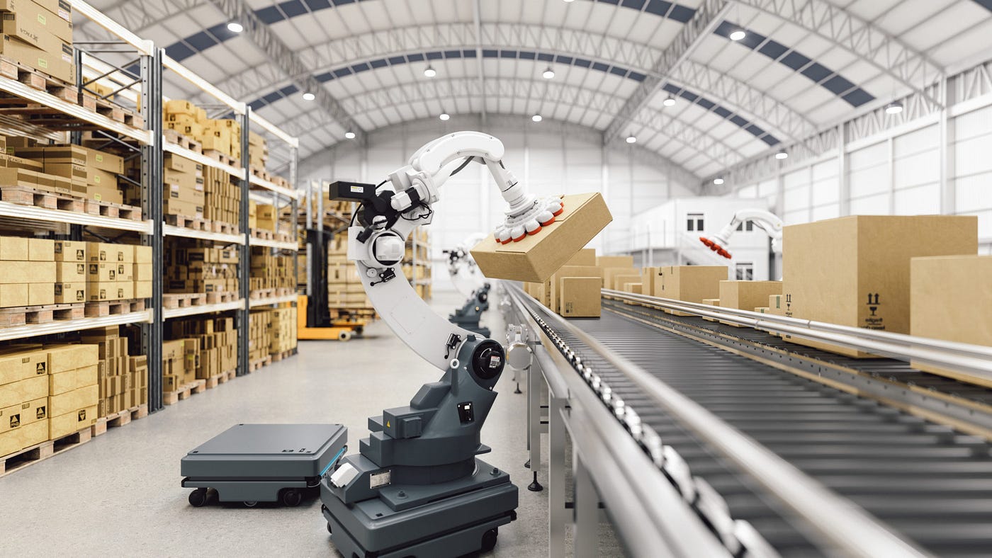 Near shelves stocked full with cardboard boxes is a conveyor belt moving boxes down a line with automated robots lifting some up from the belt for processing.