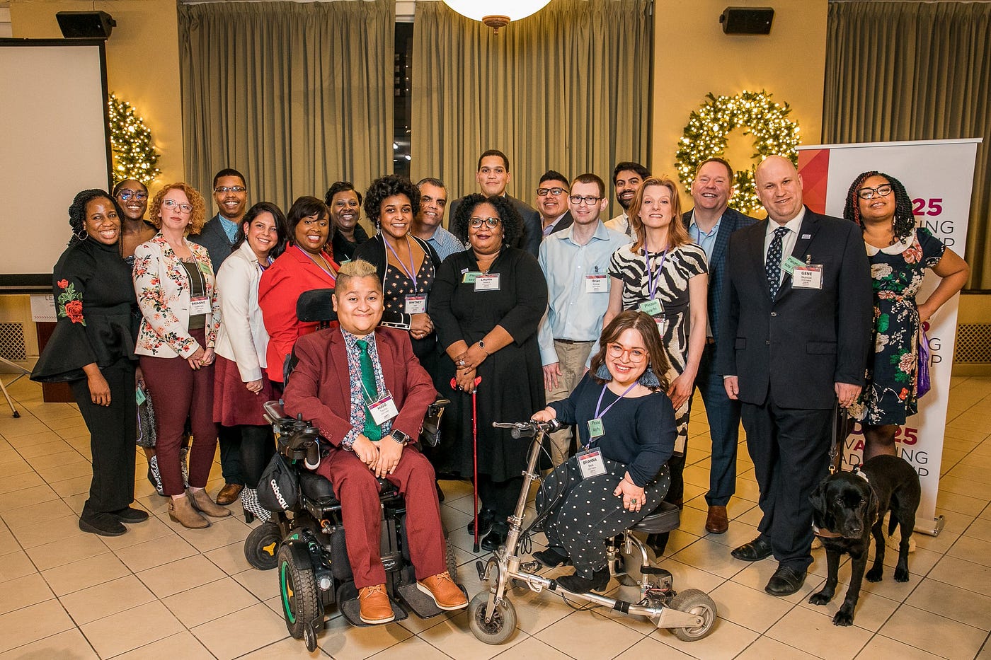 A group photo of about 20 people with visible and invisible disabilities pose with State Senator Robert Peters.