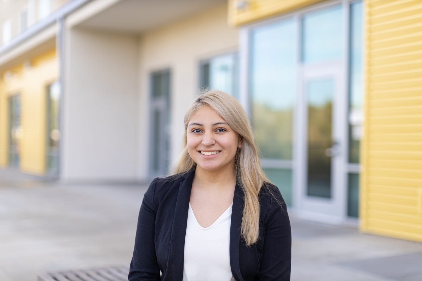 A headshot of Yulissa who is standing in front of UC Merced