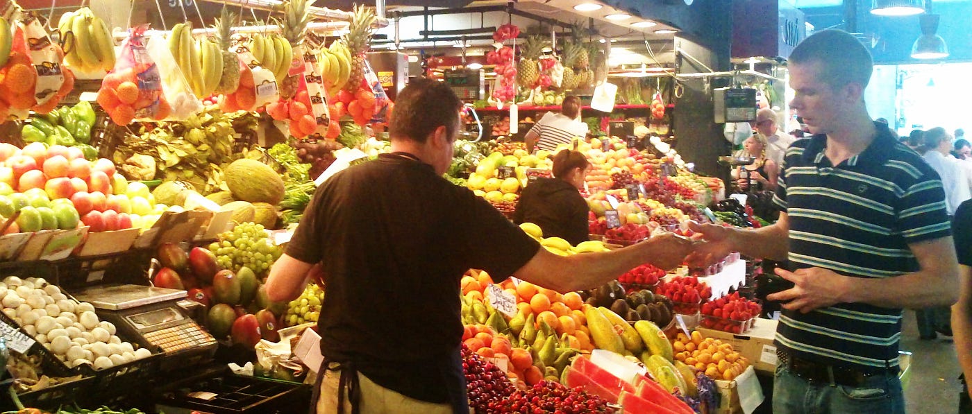 A buyer and a seller of fruit on a market