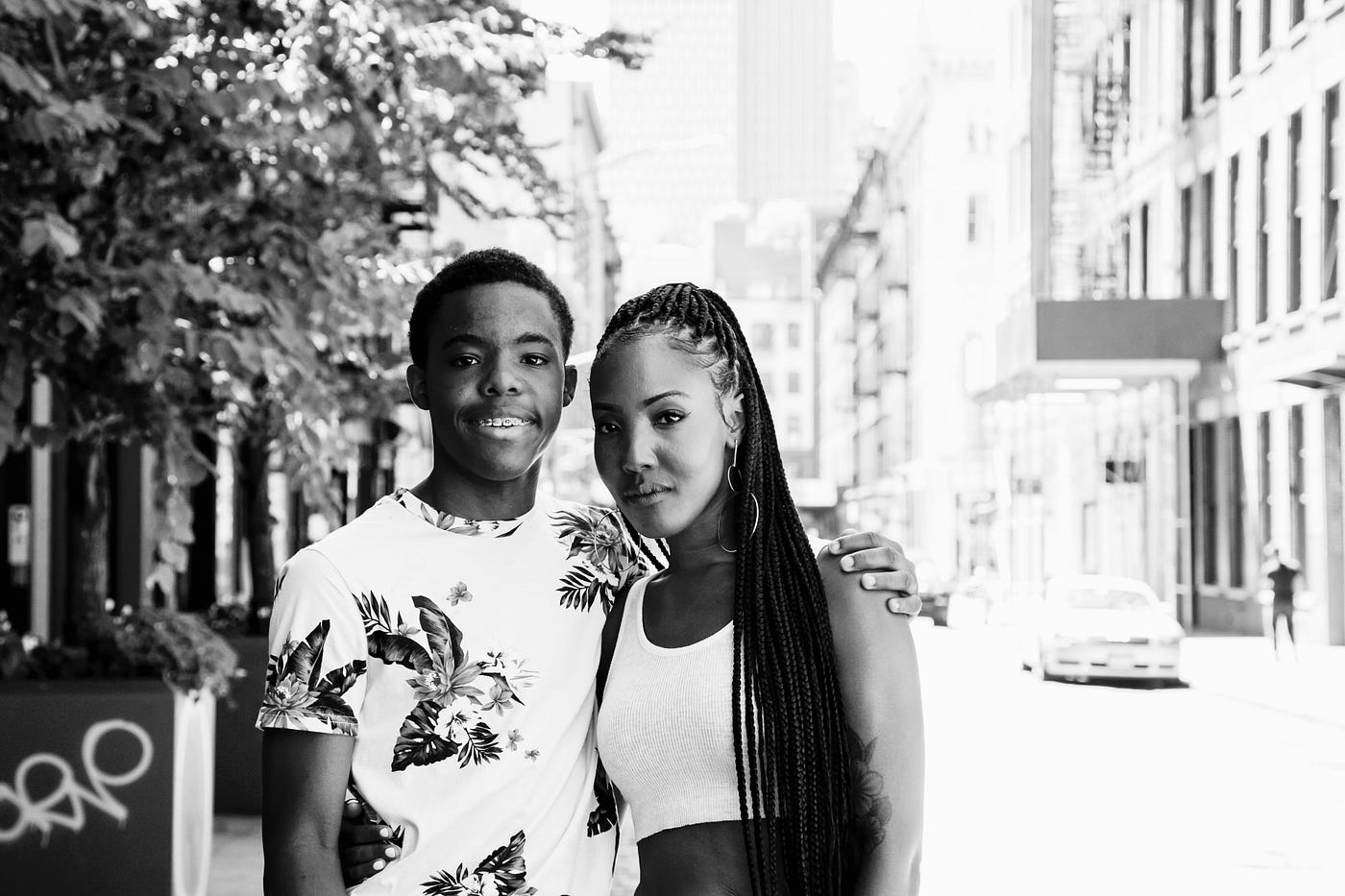 Black and white photo of the author and her son posing on a street.