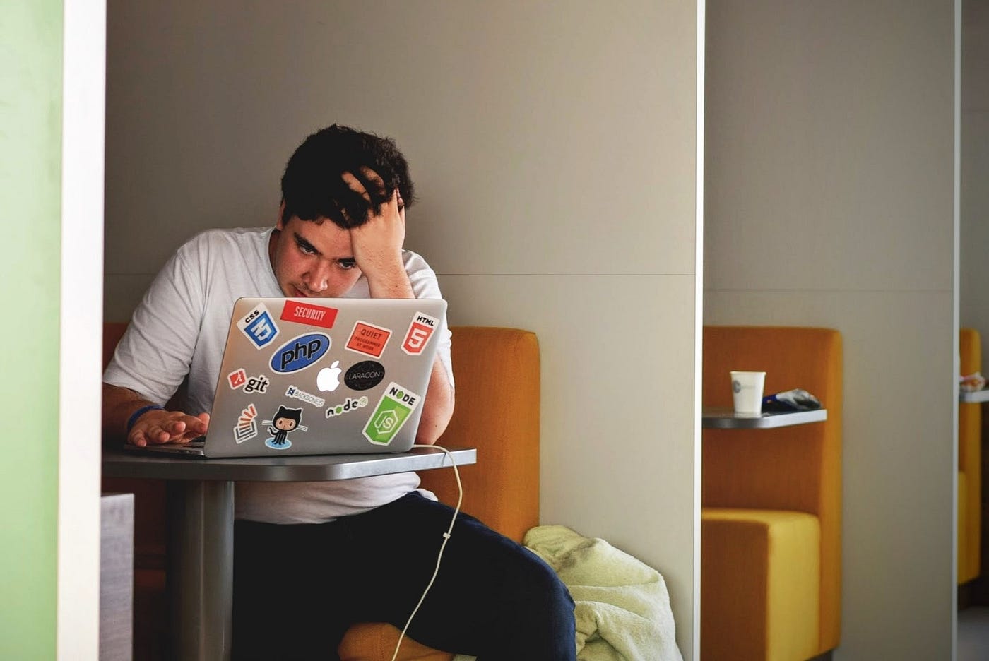 Developer looking at his laptop with hand in his hair