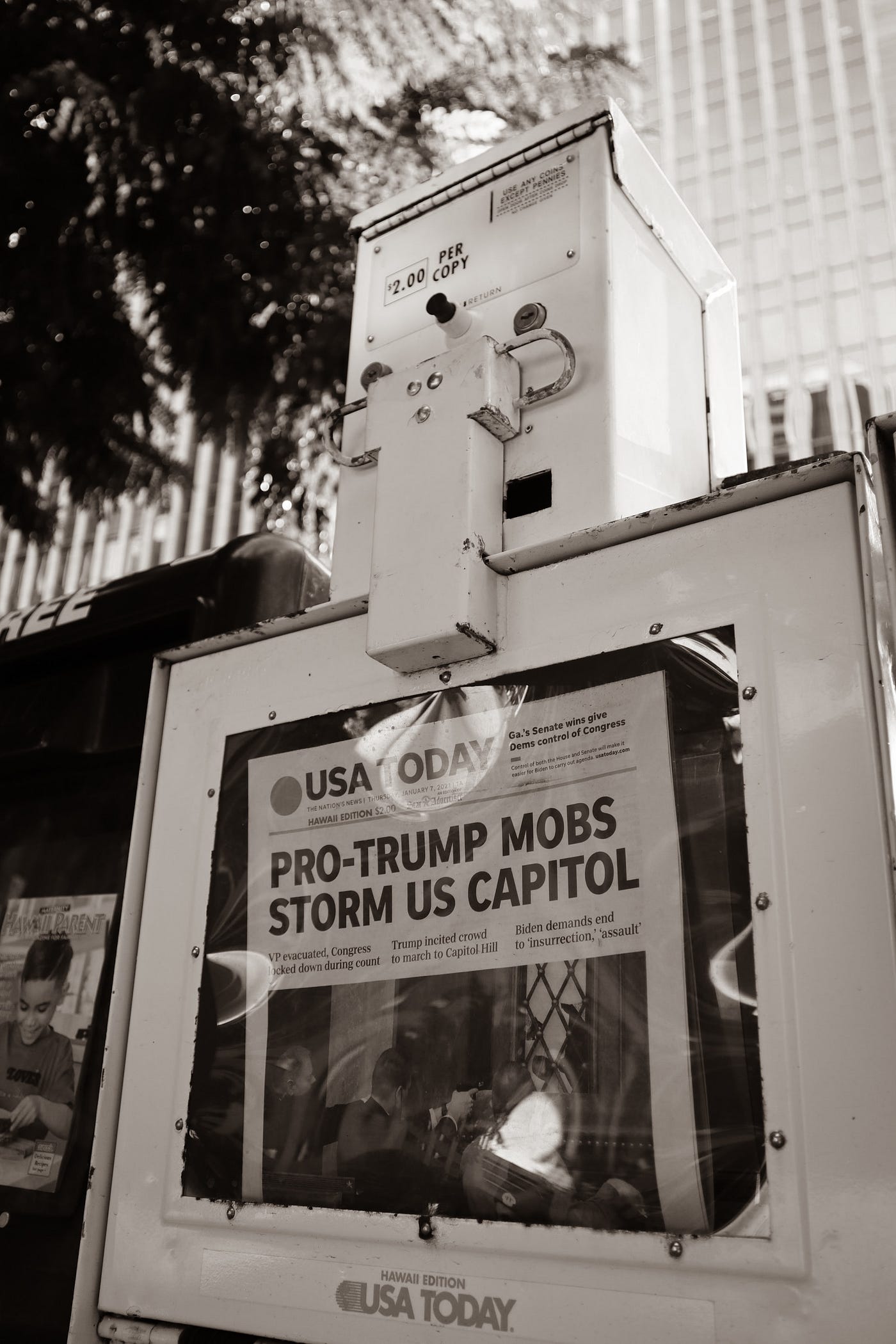 Newspaper in rack with headline ‘Pro-Trump Mob Storms US Capitol’