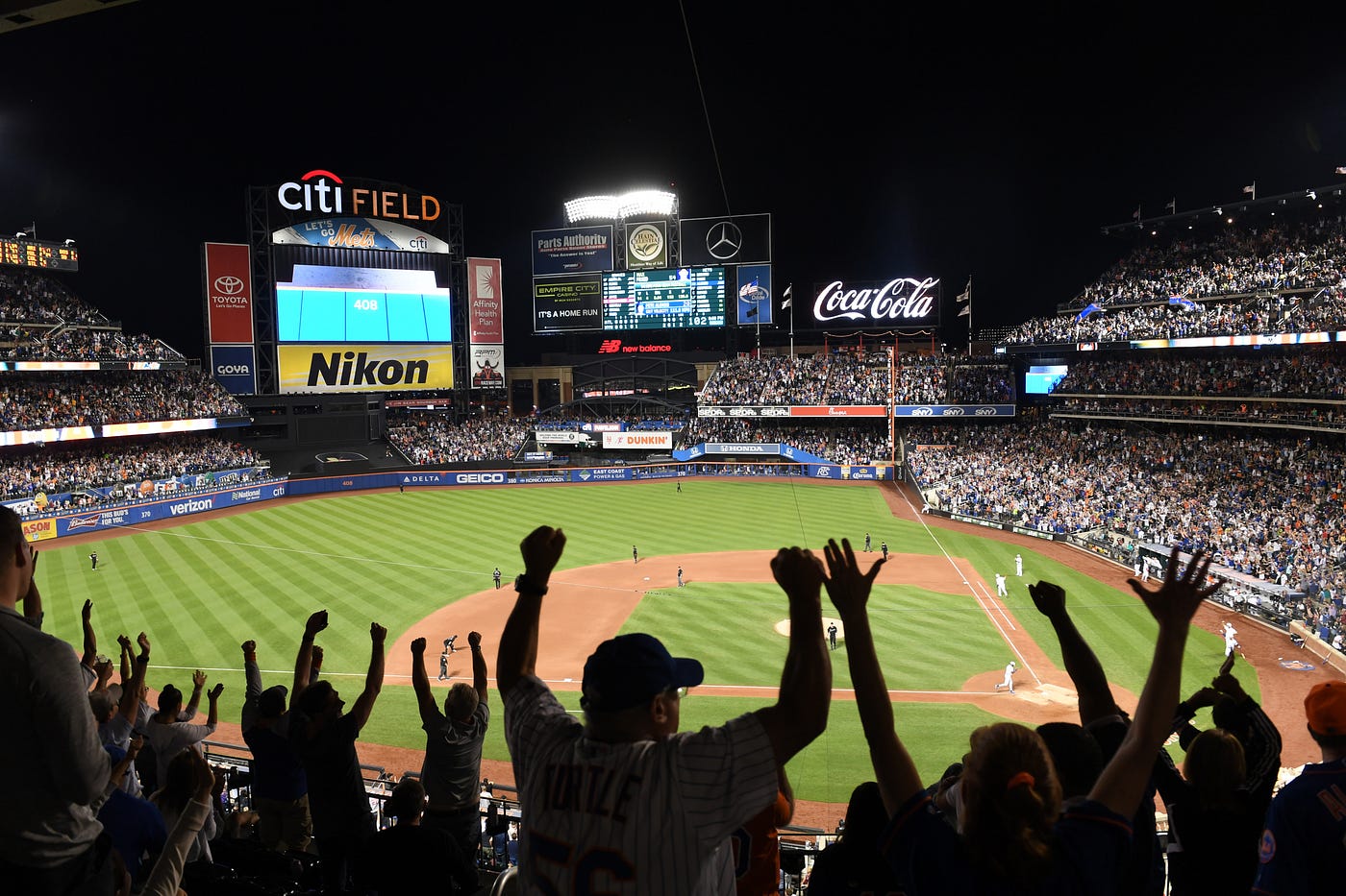 Baseball fans cheering at a baseball game