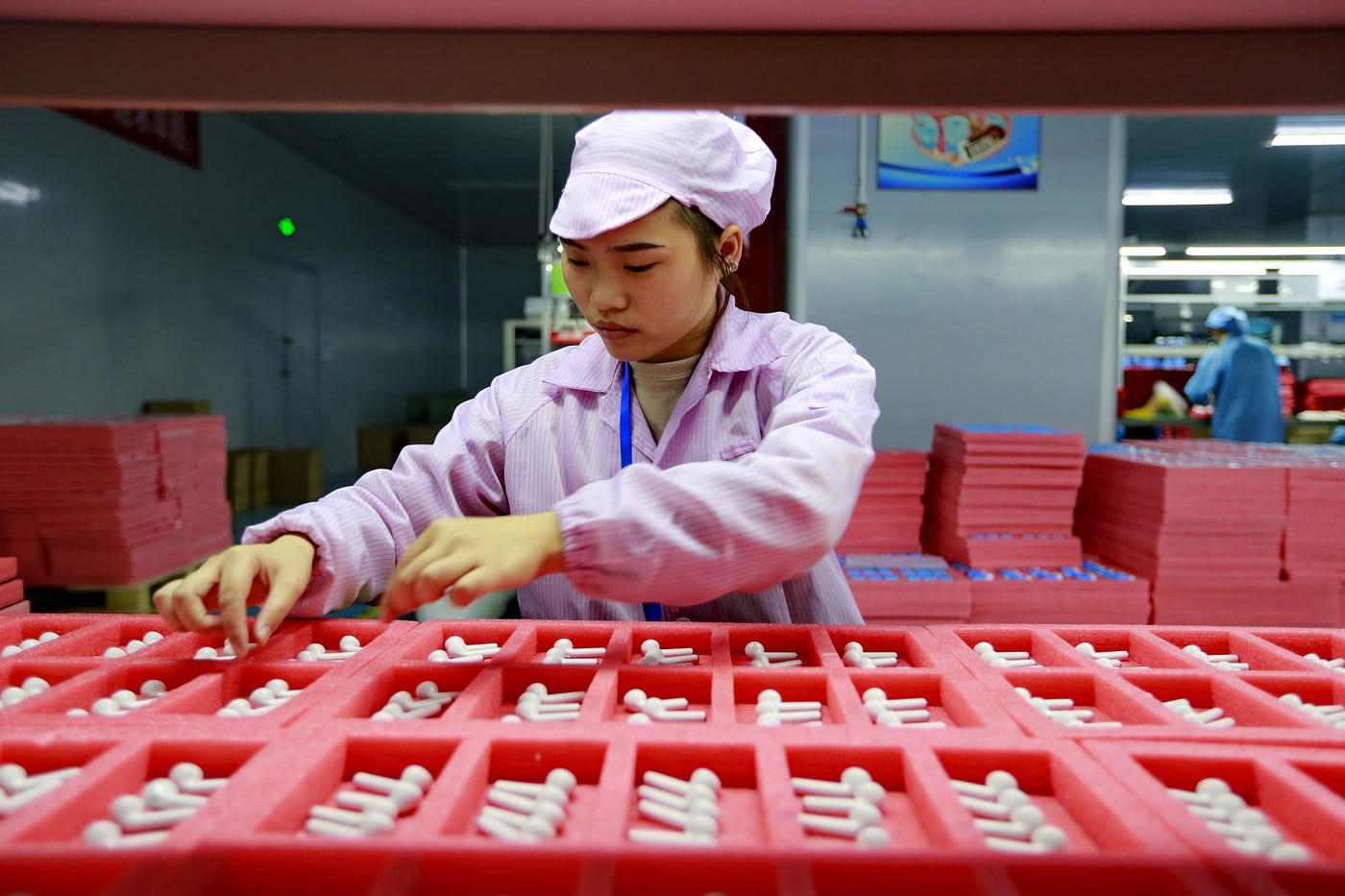 A woman worker assembles earphones for export in a factory in Suining in southwest China’s Sichuan province on Dec. 17, 2019.