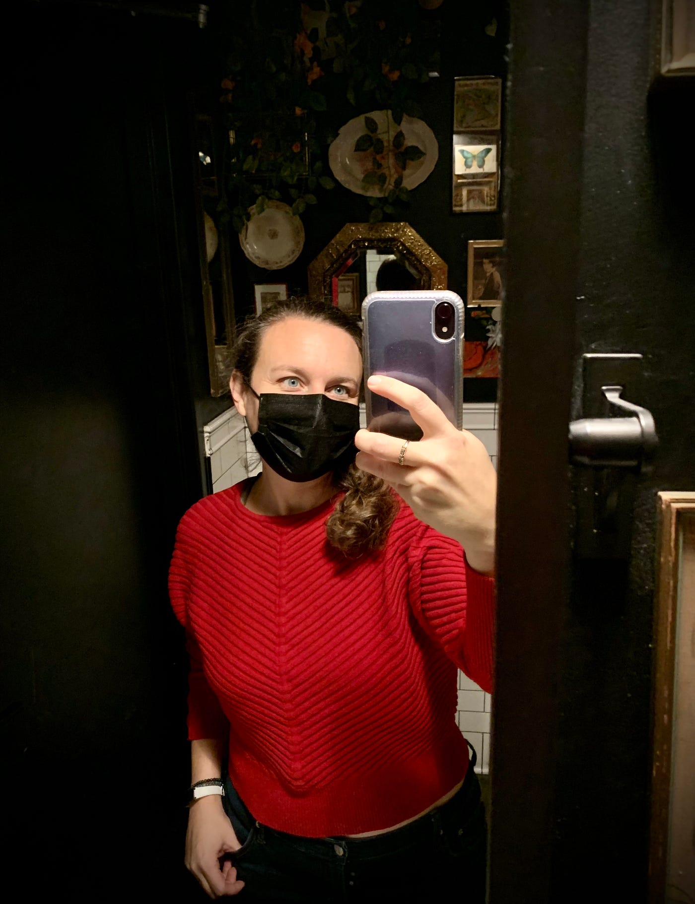Bathroom selfie of author in a red sweater bought for $7 at a thrift store.