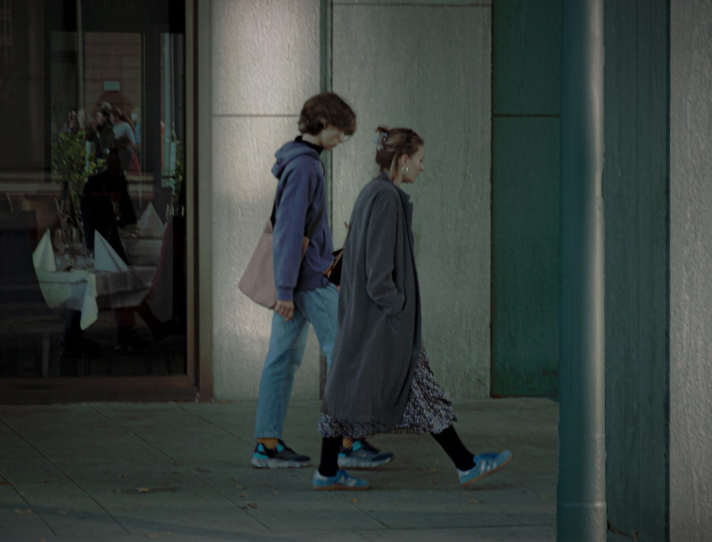Two people walking in the arcades