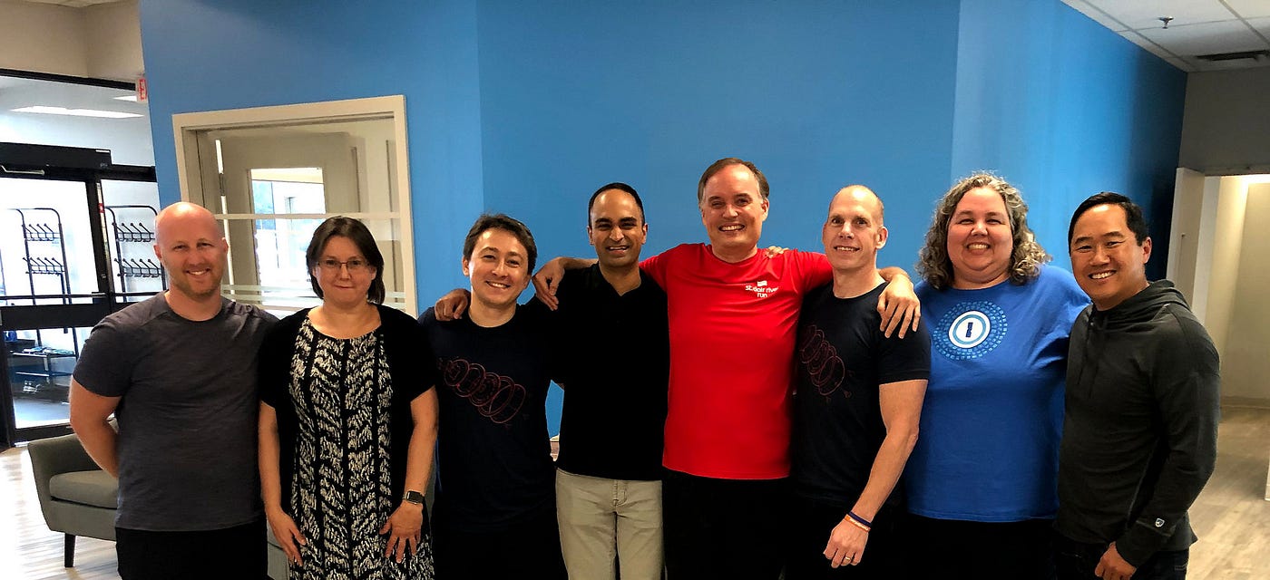 Group hug after sealing the deal in our St. Thomas, Ontario office. From left to right: Dan Levine, Natalia Karimova, Roustem