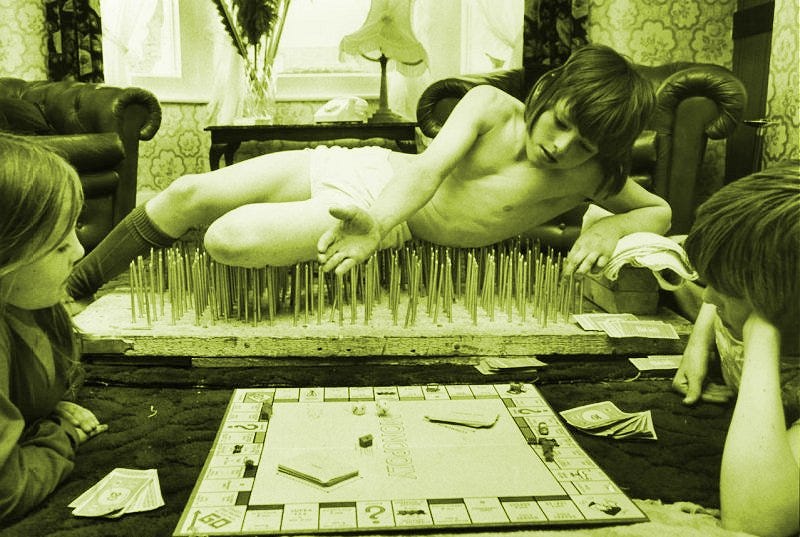 Boy on spikes playing Monopoly