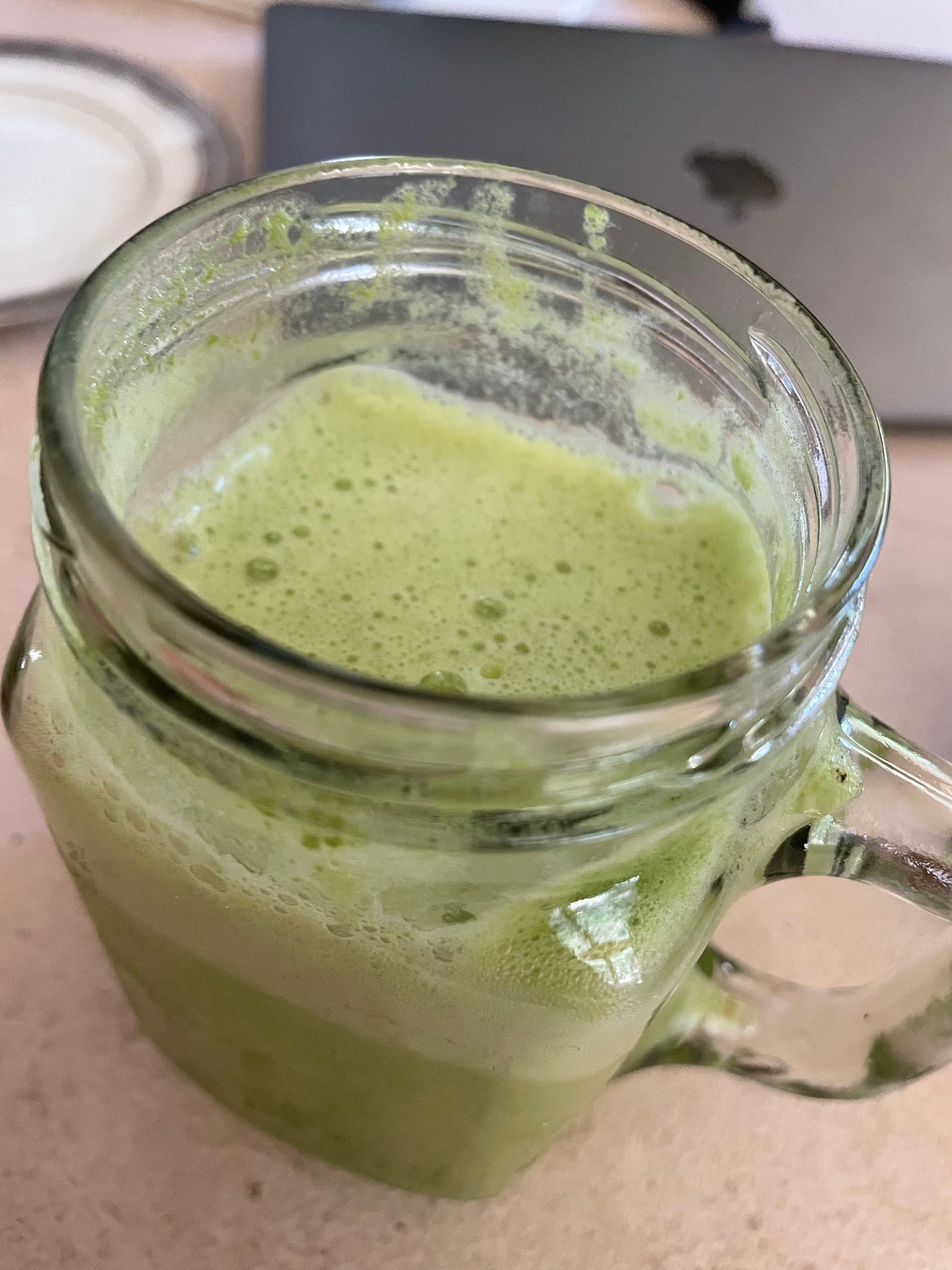 Green lemonaide in a masion jar glass.