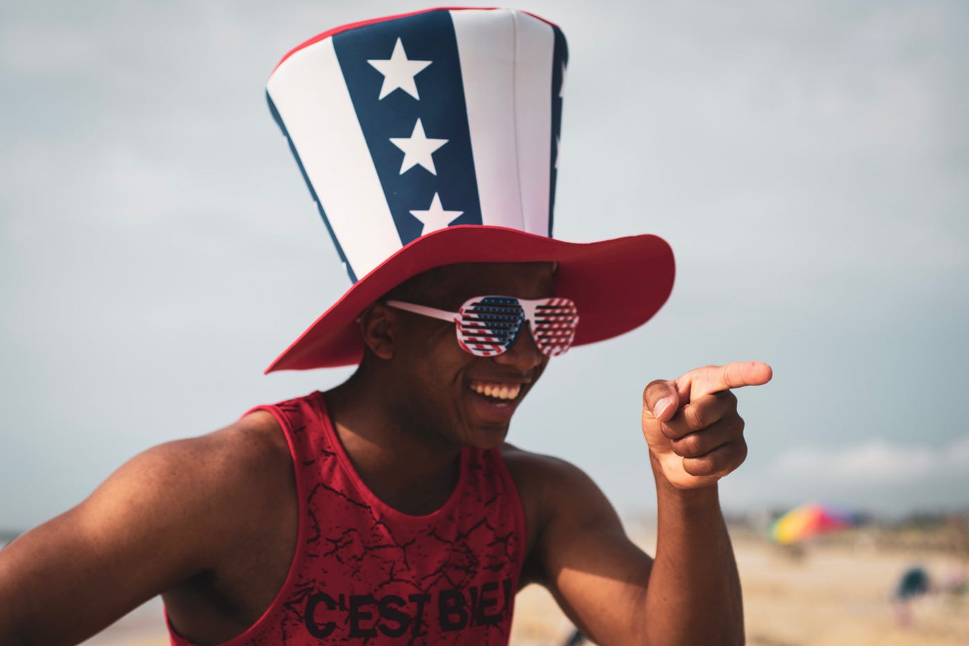 Man in big USA hat and USA glasses pointing for my How Not to Write a Product Review Post