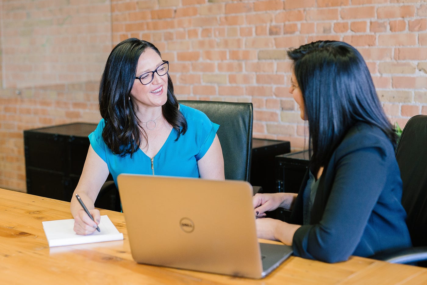 A freelance copywriter sits and discusses a project with a client.