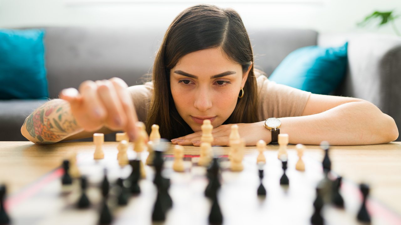 Lovely woman playing chess