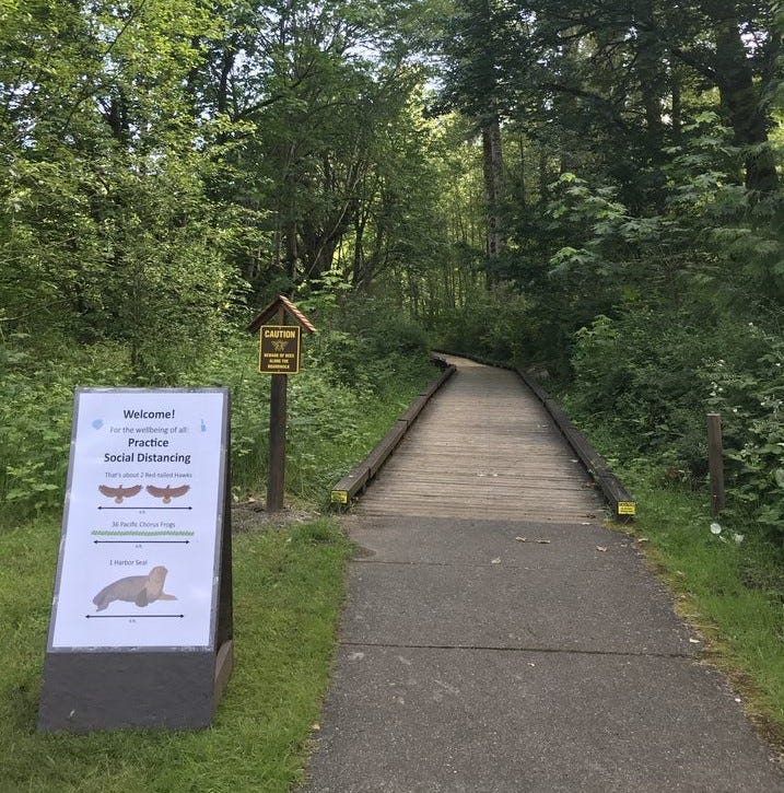Sign with Covid-19 safety information at a trail entrance