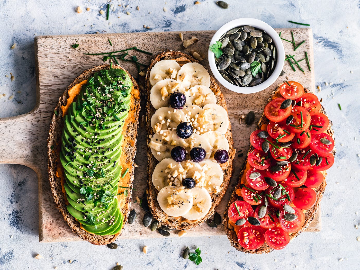 A bunch of health food on 3 pieces of bread