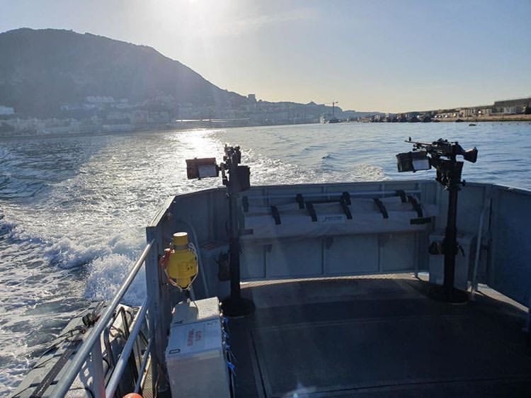 The back of the Patrol boat with the machine guns while on a sunrise patrol — with Gibraltar ‘Rock’ in the background.