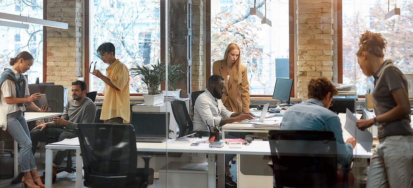 An open-concept coworking space is shared by diverse workers from different organizations.
