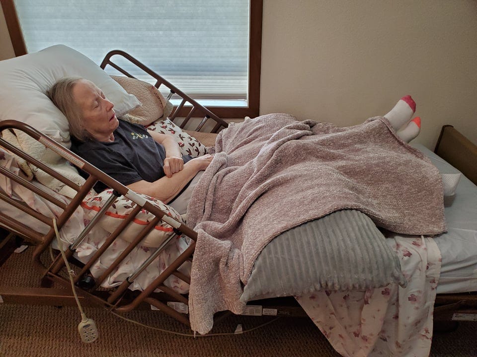Writer Lonna Whiting’s mother Beth Gregory rests comfortably in her room at a Minnesota memory care unit. Gregory has been living with dementia since 2013 and is currently receiving end-of-life hospice cares.