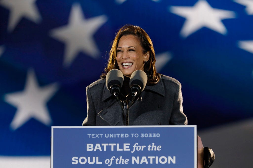 Kamala Harris giving a speech, she is smiling widely.